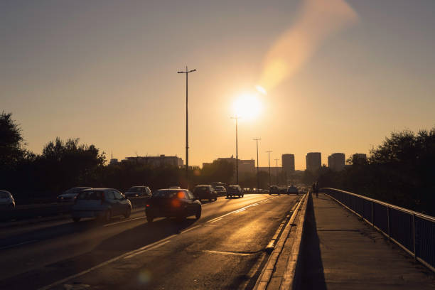 Sunset on city highway. Cars on highway in sunset in the city. Traffic rush in the city. Traffic. Cars. Sunset. Transportation. Highway.
