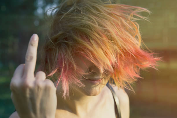 istock Red-haired girl showing middle finger gesture 1051608792