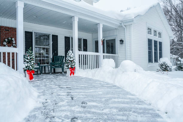 istock Footprints and Red Ribbon Bow Christmas Trees on Winter Snow Blizzard Footpath 1051616066