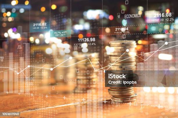 Double Explosure With Businesss Charts Of Graph And Rows Of Coins For Finance At Night City Background - Fotografias de stock e mais imagens de Finanças