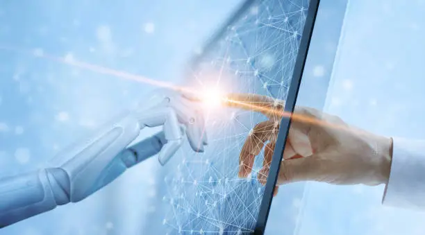 Photo of Hands of robot and human touching on global virtual network connection future interface. Artificial intelligence technology concept.