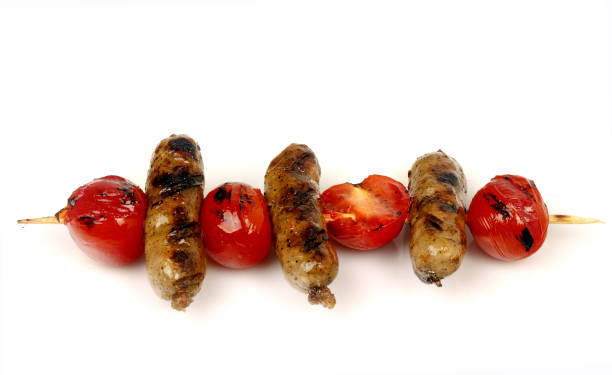 istock sausages and cherry tomatoes grill on a spit 1051617380