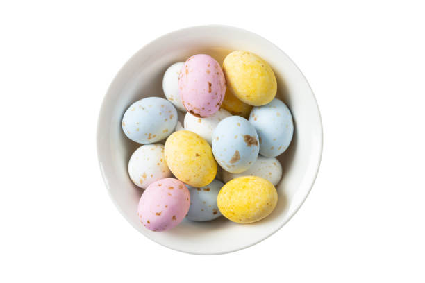 Season holidays concept. Colorful Easter eggs in a bowl, top view, cut out and isolated on white background