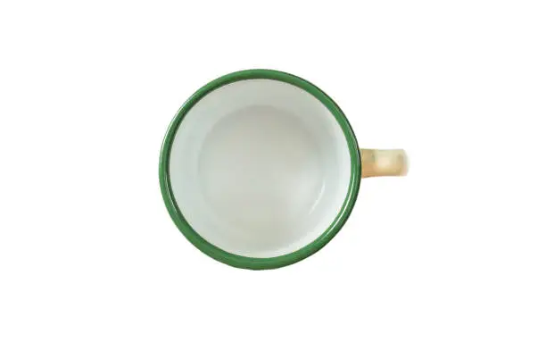 Coffee time concept. Empty coffee mug, enamel, green detail, with top view, cut out, isolated on a white background