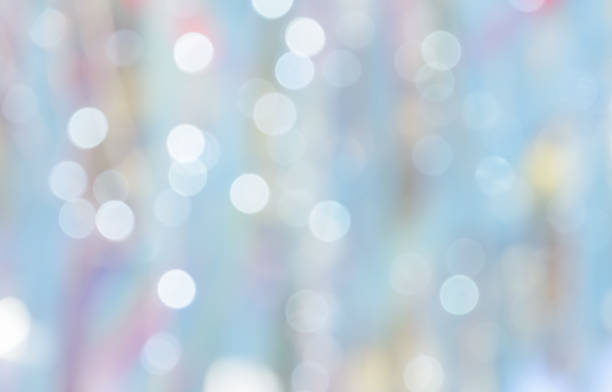 istock De-focused lights bokeh abstract on blue pastel background 1051620160
