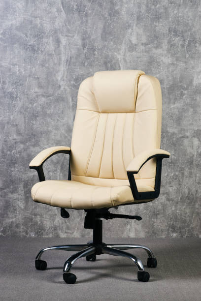 istock Leather office chair in empty room with gray texture wall background 1051620378