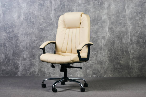 istock Leather office chair in empty room with gray texture wall background 1051620390