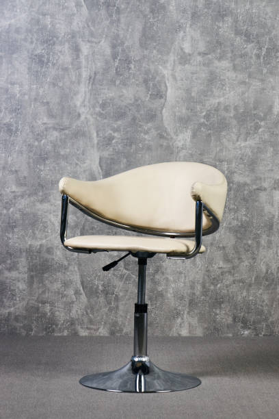 istock Leather office chair in empty room with gray texture wall background 1051620410