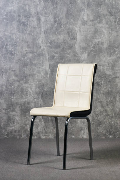 istock Leather office chair in empty room with gray texture wall background 1051620434