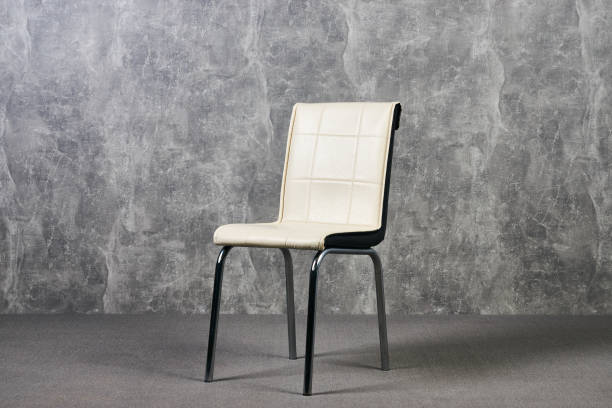 istock Leather office chair in empty room with gray texture wall background 1051620440