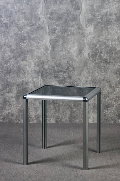 istock Modern glass table top on gray texrure wall background 1051620450