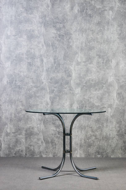 istock Modern glass table top on gray texrure wall background 1051620568