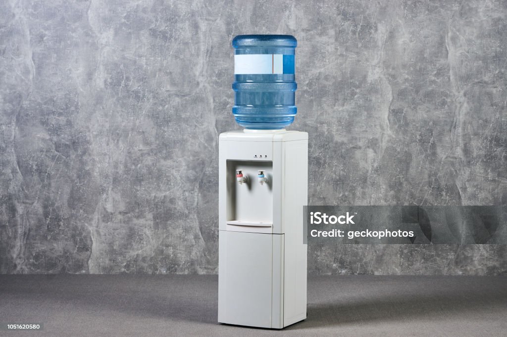White Water Cooler Gallon In Office Against Gray Textured Wall Background  Stock Photo - Download Image Now - iStock