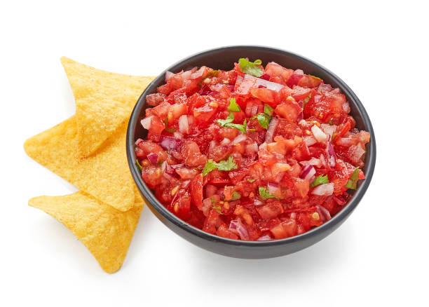 istock Fresh Tomato salsa with nacho chips isolated on white background 1051626518