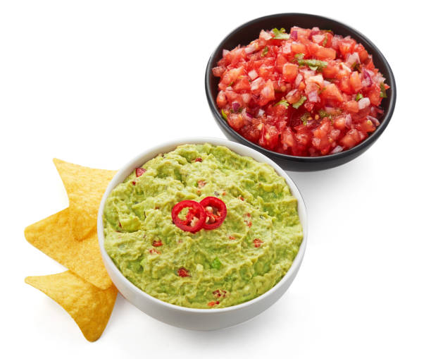 istock Fresh guacamole and salsa with nachos isolated on white background 1051626534