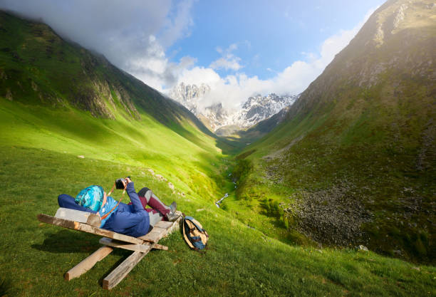 istock Traveler with backpack relax and enjoys view of the mountain range. 1051632886