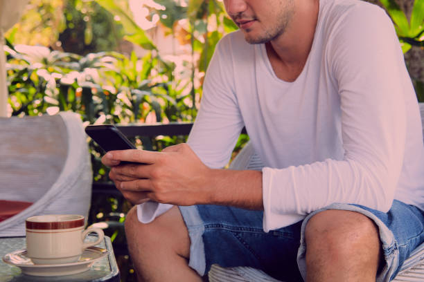 istock Modern man drinking coffee and using cellphone outdoors. 1051638744
