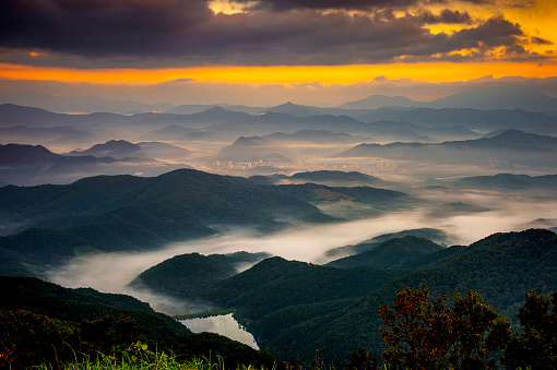Scenic view of fog covering mountains in Laos at sunrise