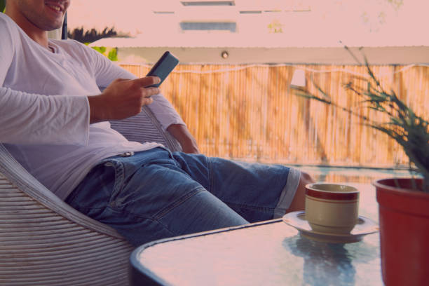 istock Modern man drinking coffee and using cellphone outdoors. 1051648704