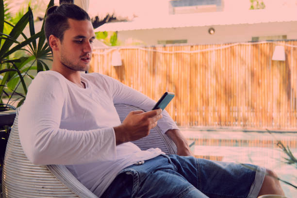 istock Modern man drinking coffee and using cellphone outdoors. 1051651320