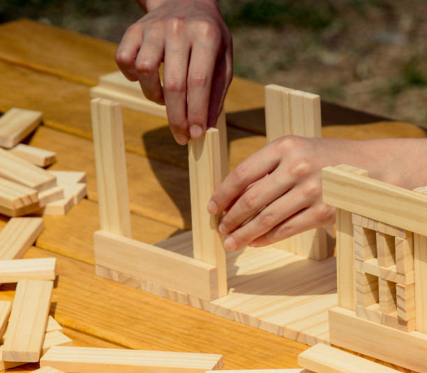 istock Hand holding wooden puzzle element in hand 1051652078