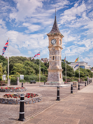 Exmouth, Devon, UK - The Jubilee Clock Tower on the Esplanade at Exmouth, Devon, with flags flying for Armed Forces Day.