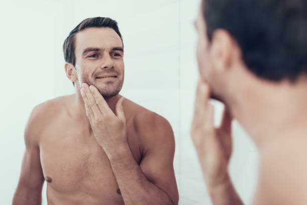 istock Mirror Reflection of Man Brush Teeth in Bathroom 1051656182