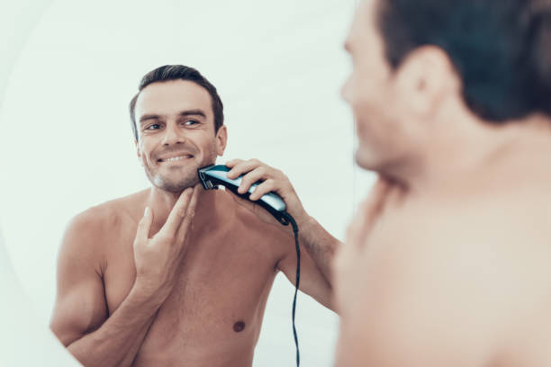 mirror reflection of man brush teeth in bathroom - shaving men electric razor reflection imagens e fotografias de stock