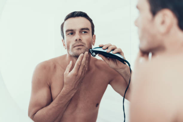 mirror reflection of man brush teeth in bathroom - shaving men electric razor reflection imagens e fotografias de stock