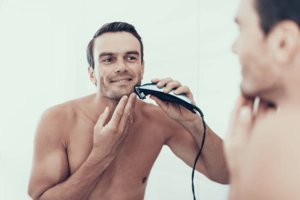 mirror reflection of man brush teeth in bathroom - shaving men electric razor reflection imagens e fotografias de stock