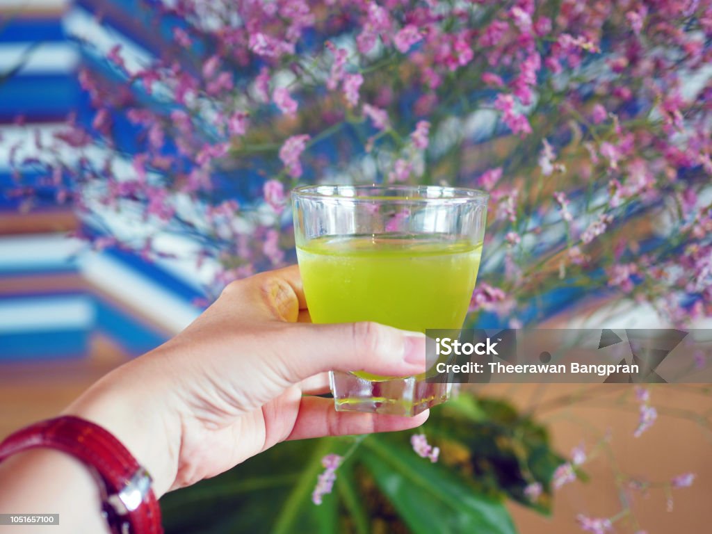 A refreshing glass of iced sweet and sour lemongrass and mint punch. A refreshing glass of iced sweet and sour lemongrass and mint punch. Selective focus. Beauty Stock Photo