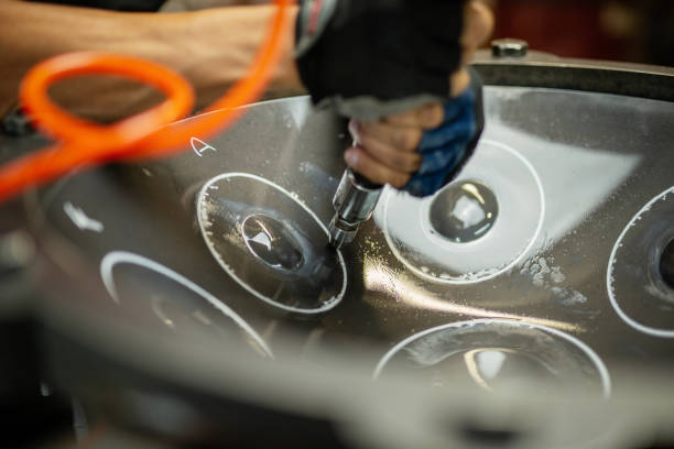 Hands constructing handpan stock photo