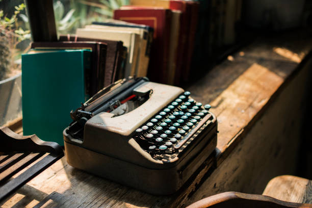 istock Closeup of retro typewriter on wooden table 1051659160