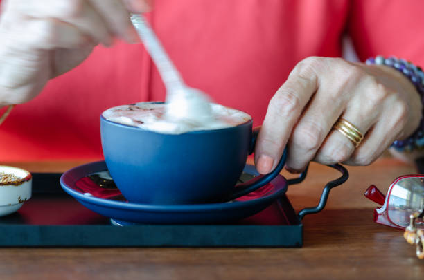 istock Woman is mixing the cup cappuccino 1051660190