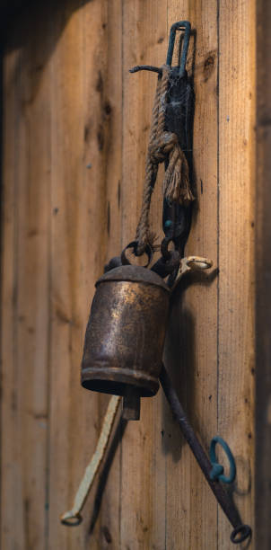 istock Old rusty farm tools hung up on a rough wooden door in a bright light - Sheffield 1051662772