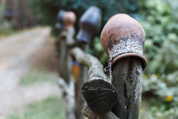istock Clay pitcher hang on a wooden fence along the forest path. 1051663660