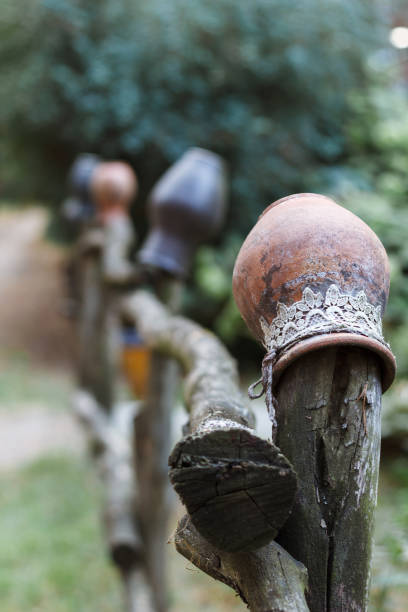 istock Clay pitcher hang on a wooden fence along the forest path. 1051663662