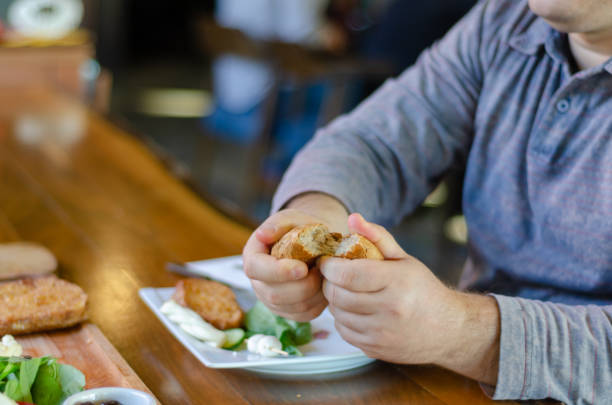 istock The man takes bread in his hand at the breakfast 1051666684