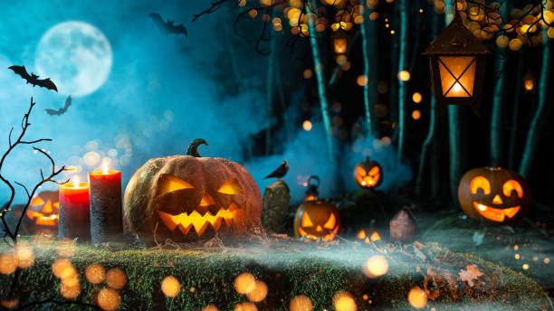 istock Halloween pumpkins on dark spooky forest. 1051666844