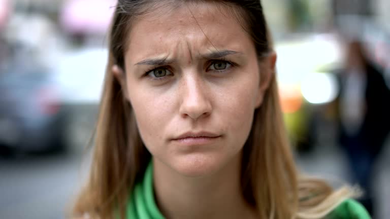 Charming young woman making faces at camera