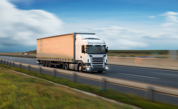 istock Truck with container on road, cargo transportation concept. 1051669970