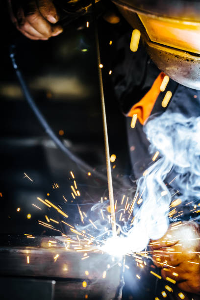 istock Industrial Worker at the factory welding closeup. Selective focus. 1051671196