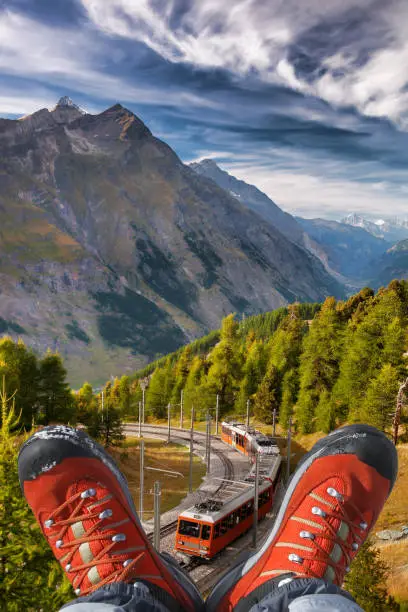 Gornergrat train with hiking boots in Zermatt, Swiss Alps.