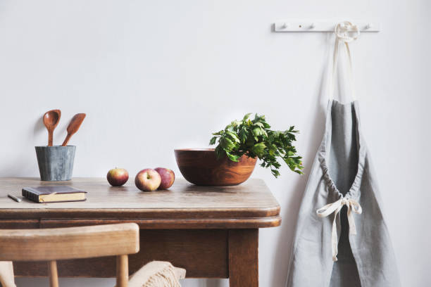 Vintage and coozy kitchen interior with mock up photo frame, wooden bowl and kitchen accessories. Minimalistic concept of kitchen space.