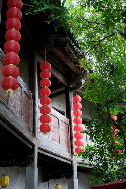 istock Red lantern plaque hanging in an old wooden house 1051683386