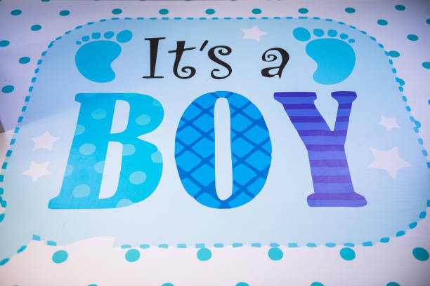 Newborn baby holding gift box while sleeping