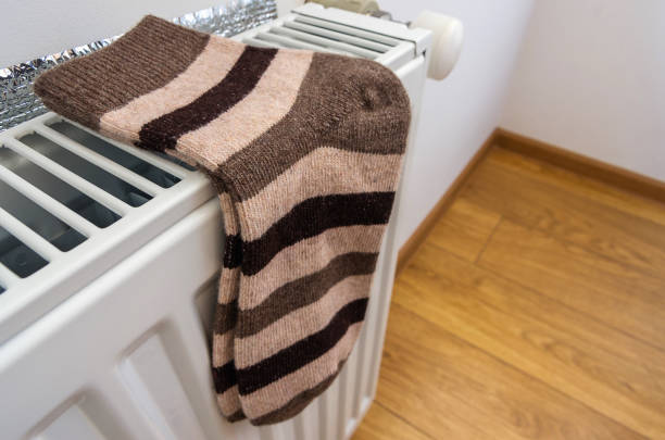 istock Warm woolen socks on the heater. 1051686082