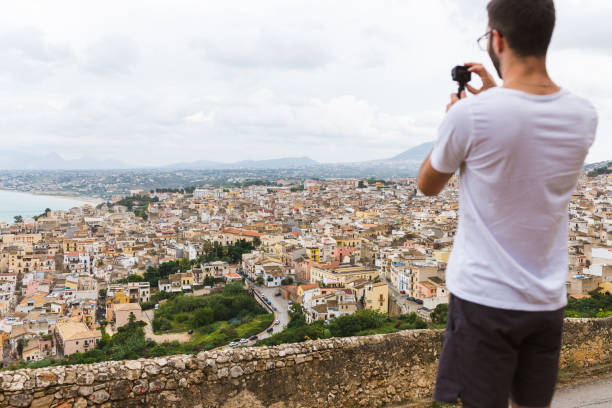istock Man standing above Castellammare del Golfo, Sicily 1051690756