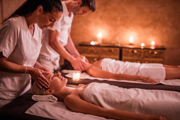 istock Young therapists massaging women at beauty spa. 1051691216