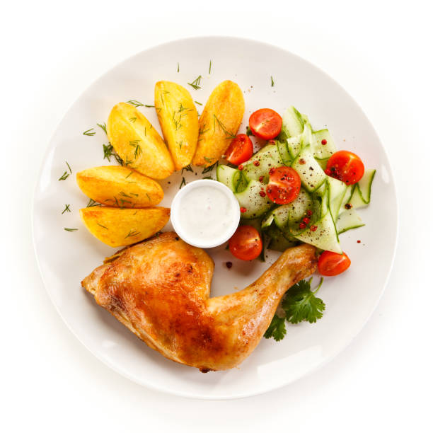 istock Roast chicken leg baked potatoes and vegetable salad 1051692618